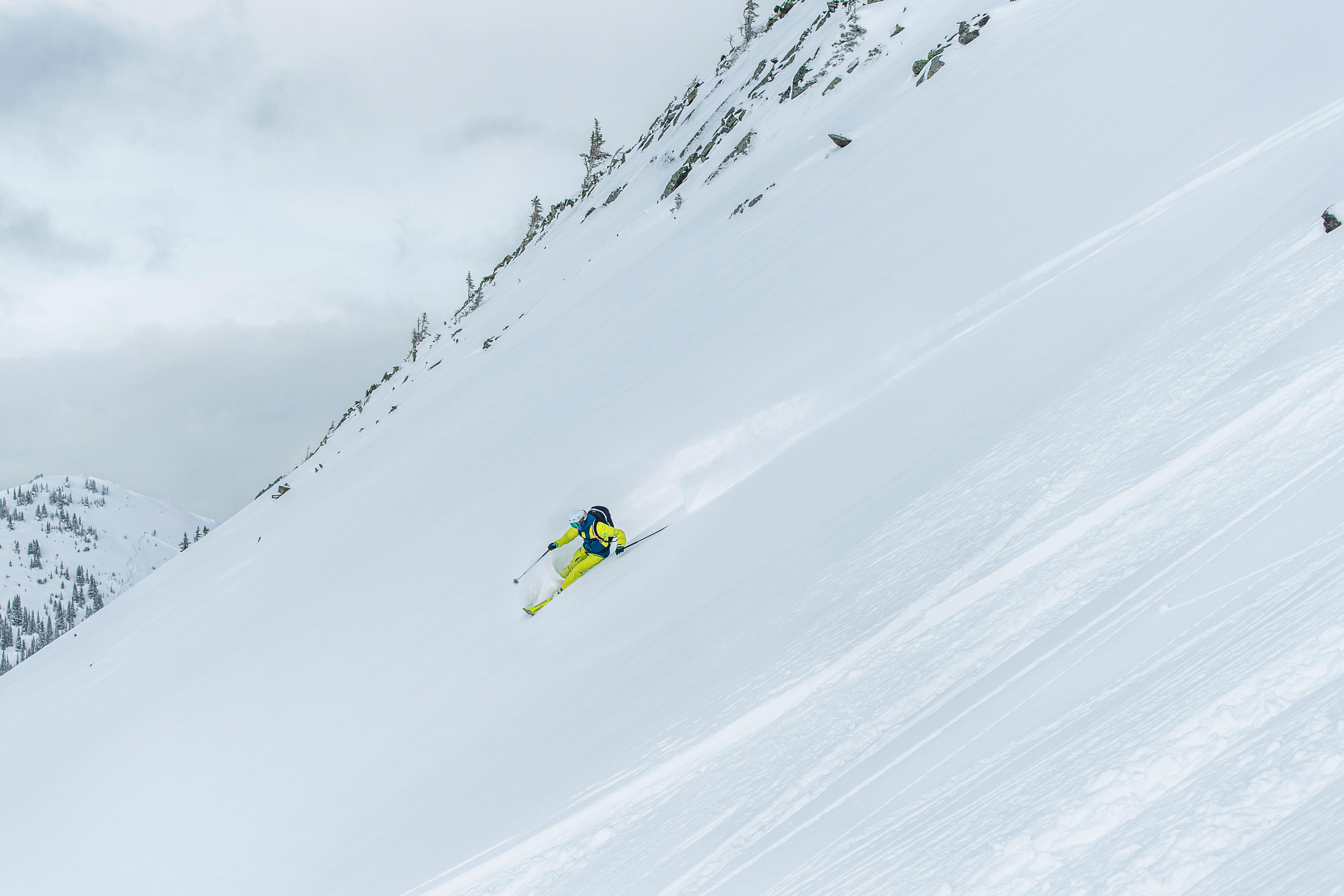 A skier bombing down a steep slope