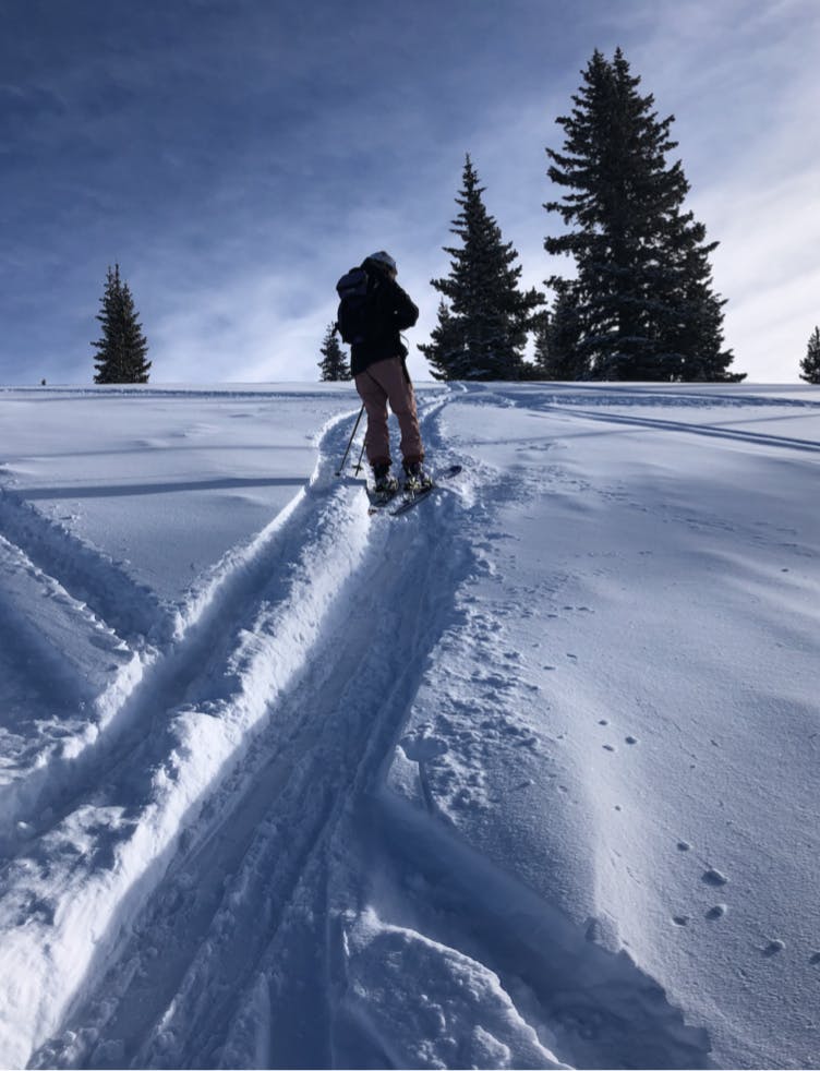 A skier walking uphill. 