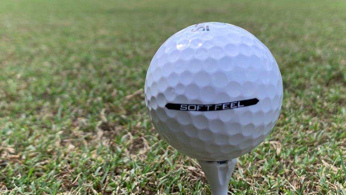 A Srixon Soft Feel 12 Golf Ball on a tee. 