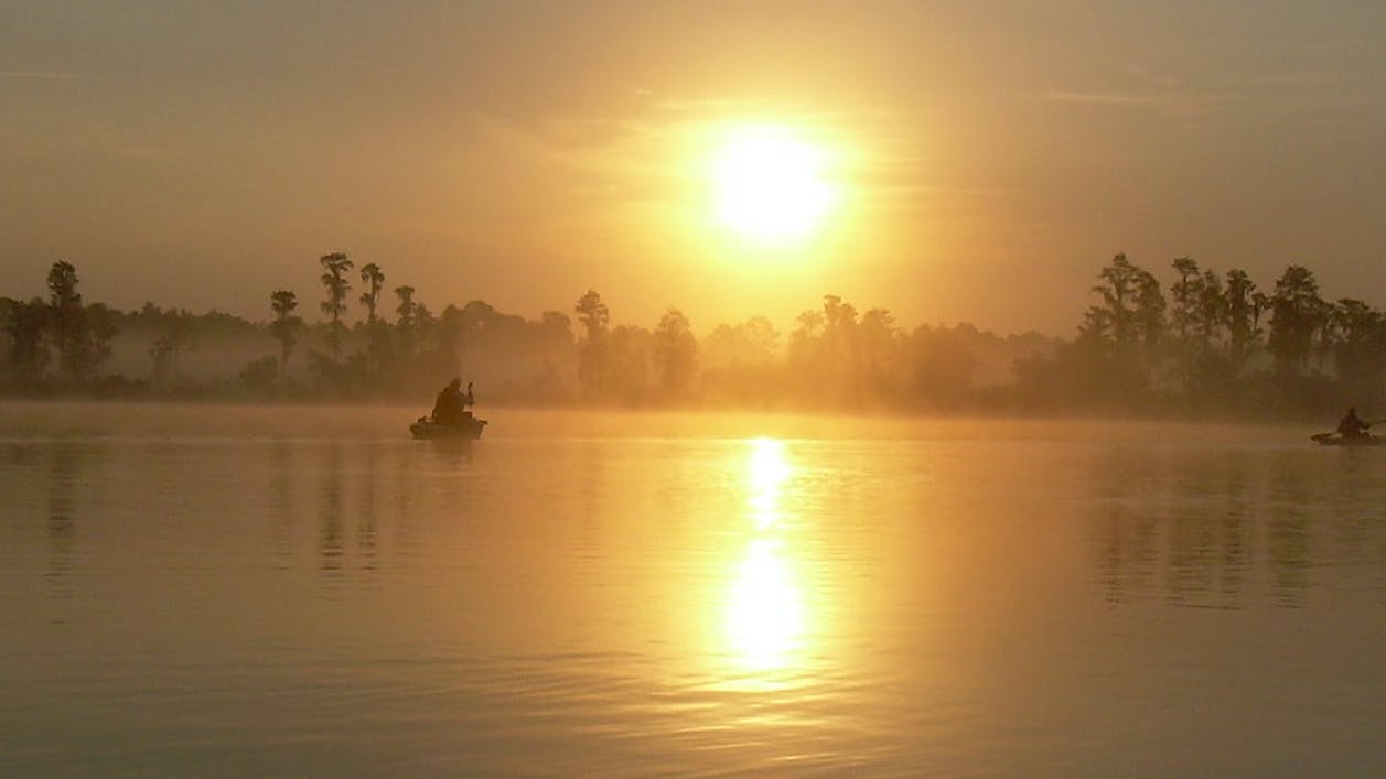 A kayak on the water at sunrise. 