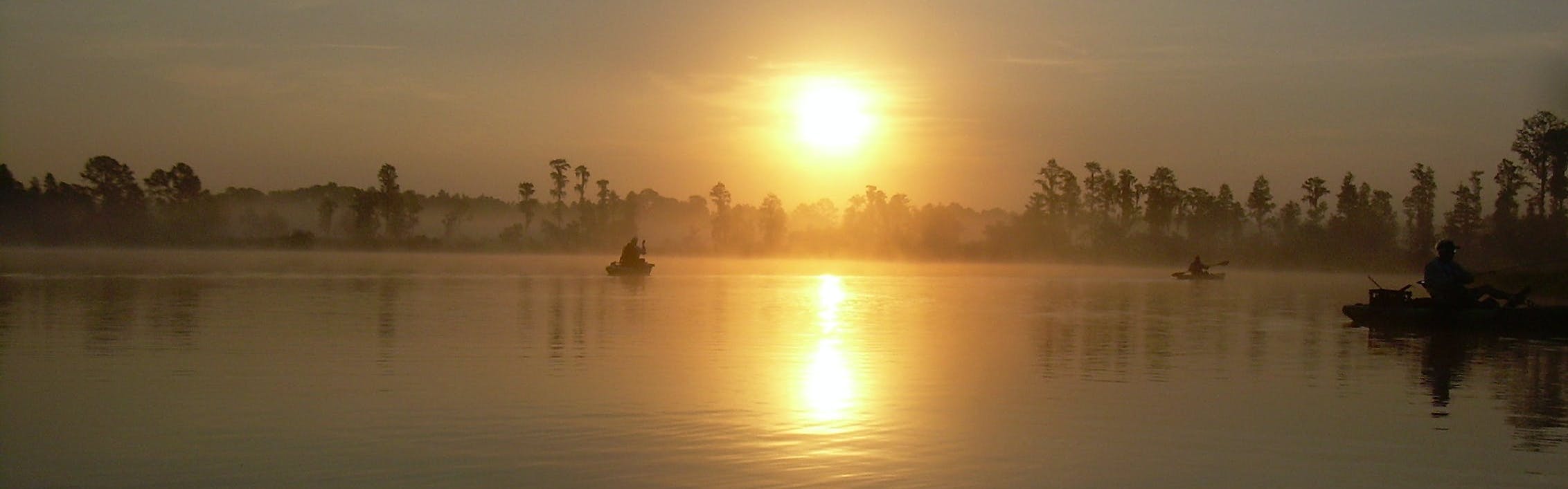 A kayak on the water at sunrise. 