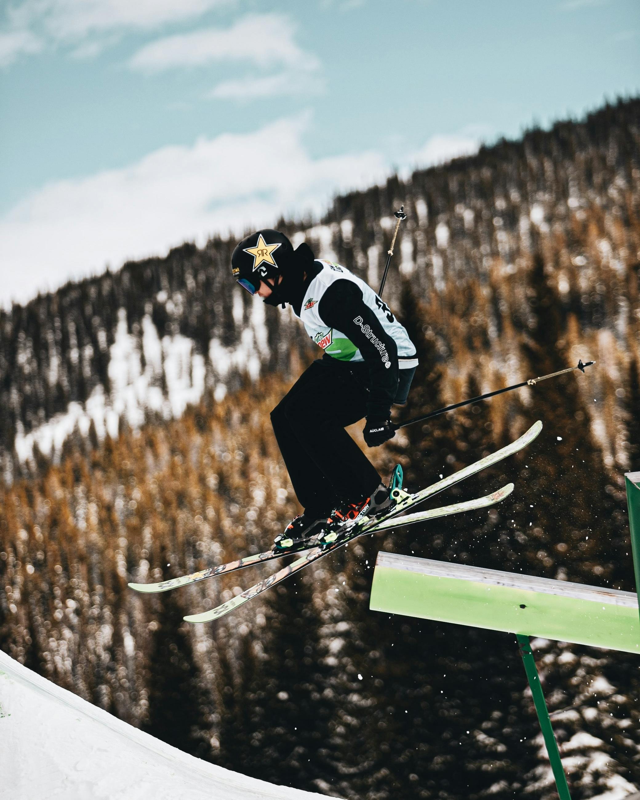 A skier in the terrain park executing a jump