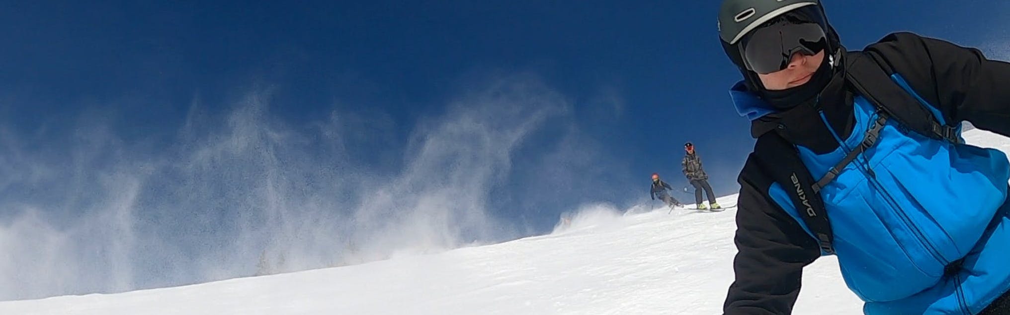 A skier shredding with the Smith I/O MAG XL goggles.