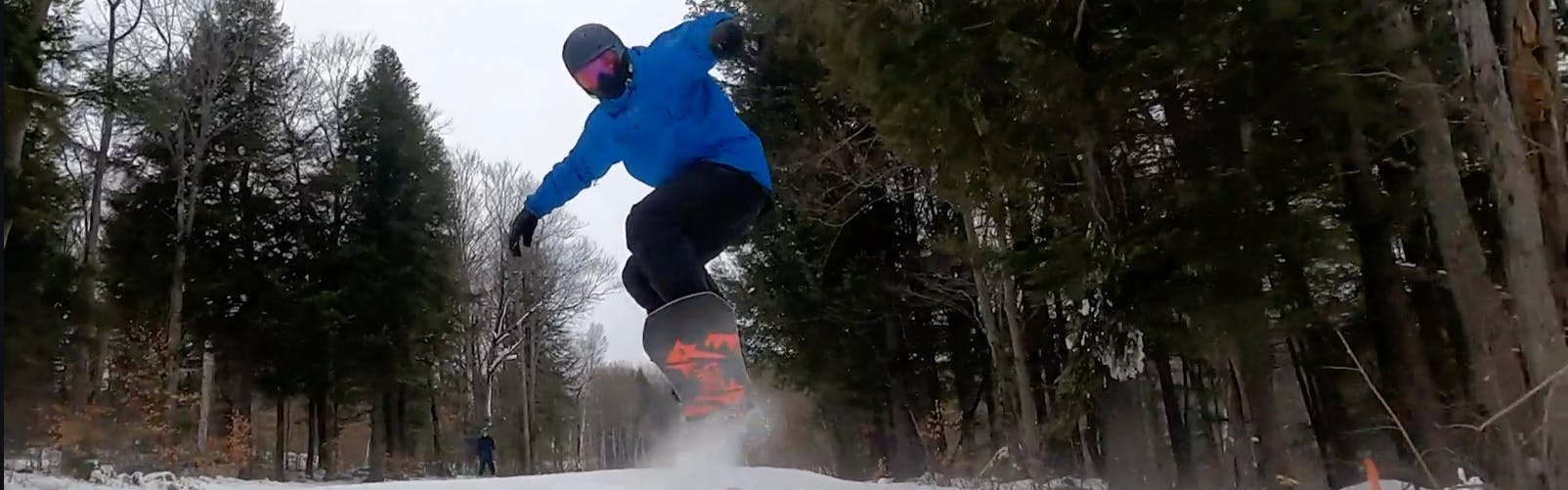 Curated expert Franco DiRienzo landing a jump with the Jones Mountain Twin snowboard