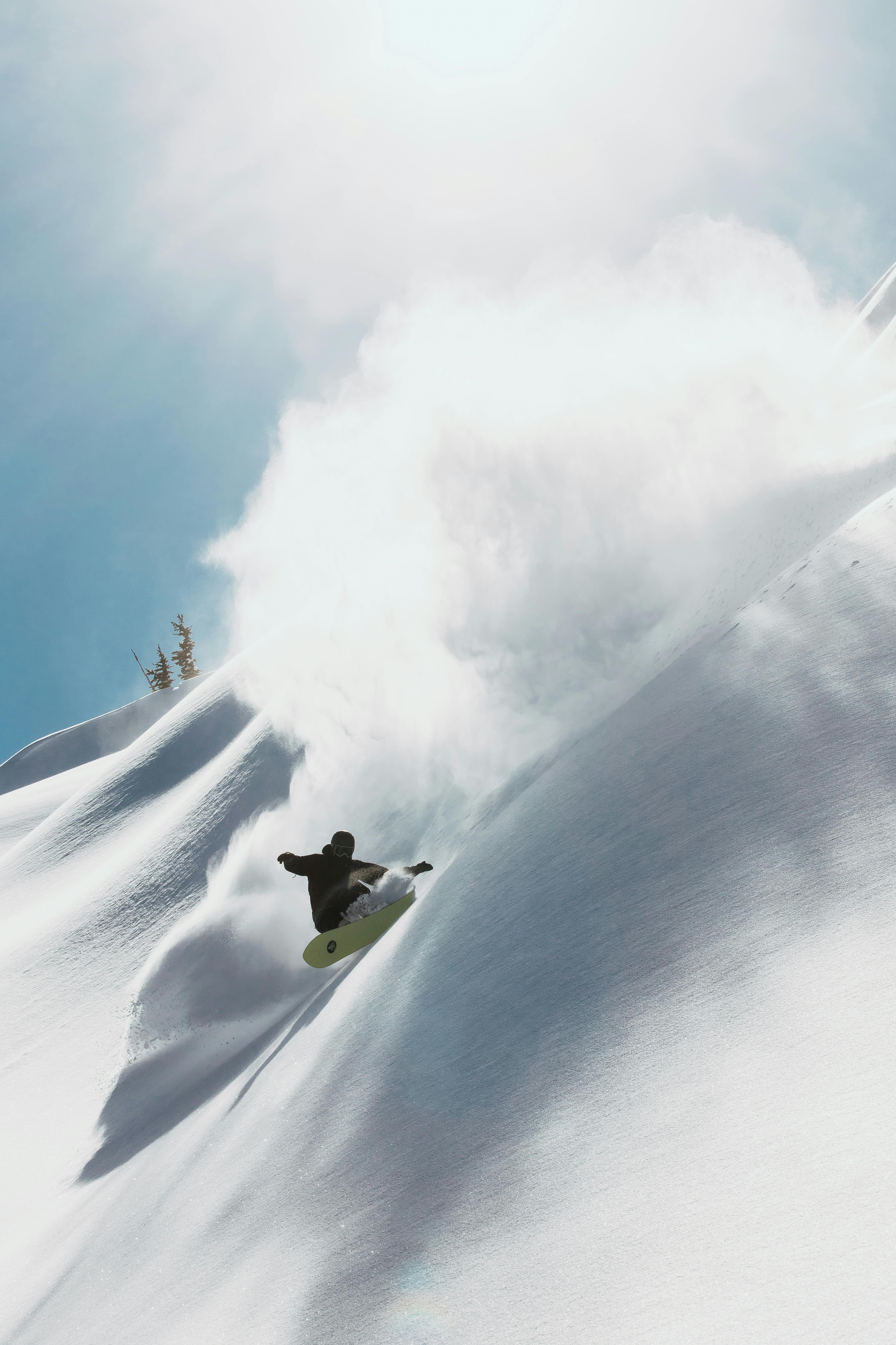 Dave carves on his board, sending up a huge cloud of powder on a bluebird day. 
