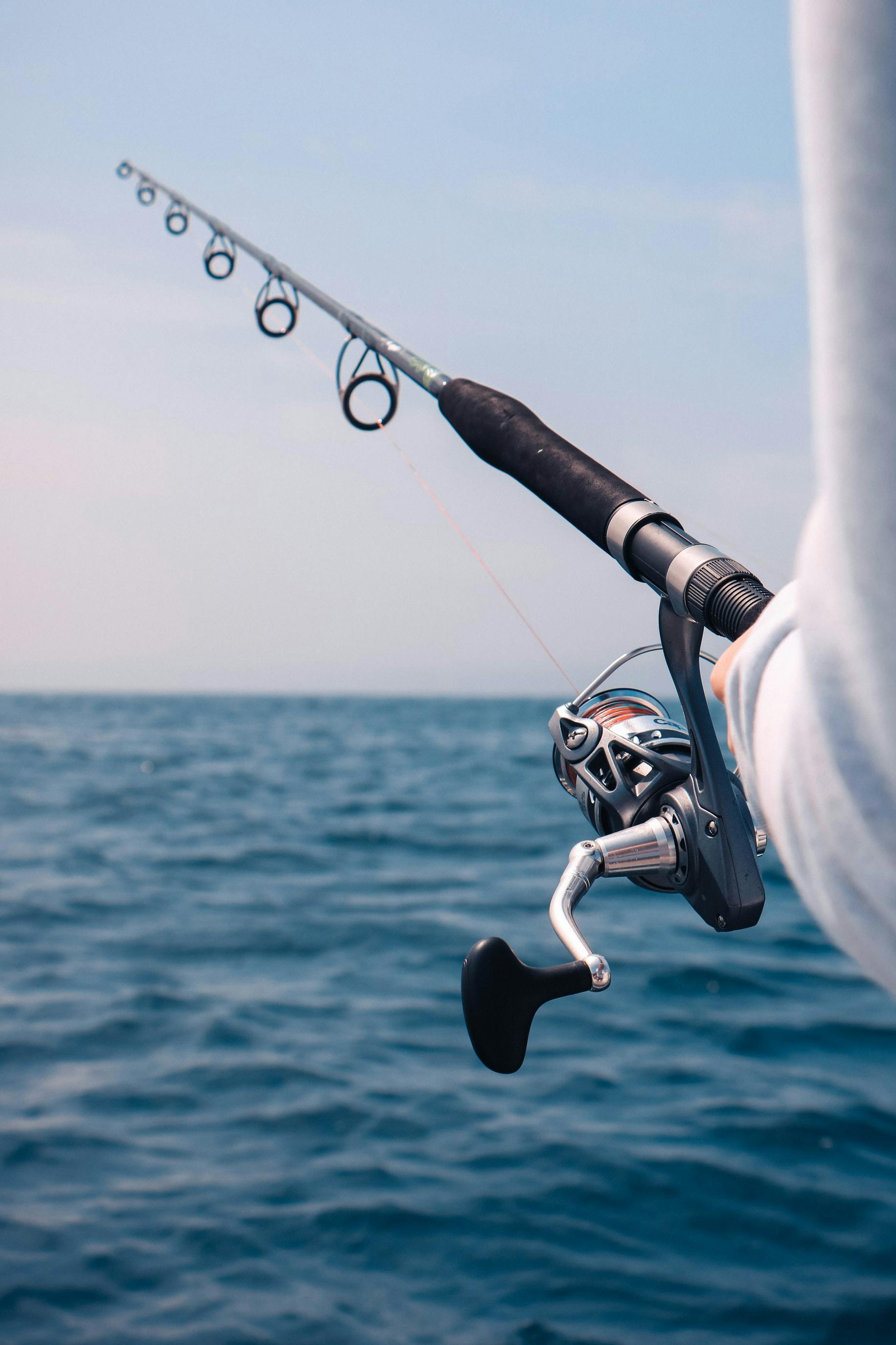 Closeup on a reel and rod being used for saltwater fishing