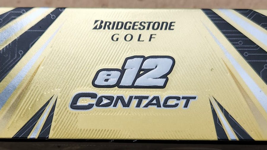 A box of the Bridgestone 2021 e12 Contact White Golf Balls.