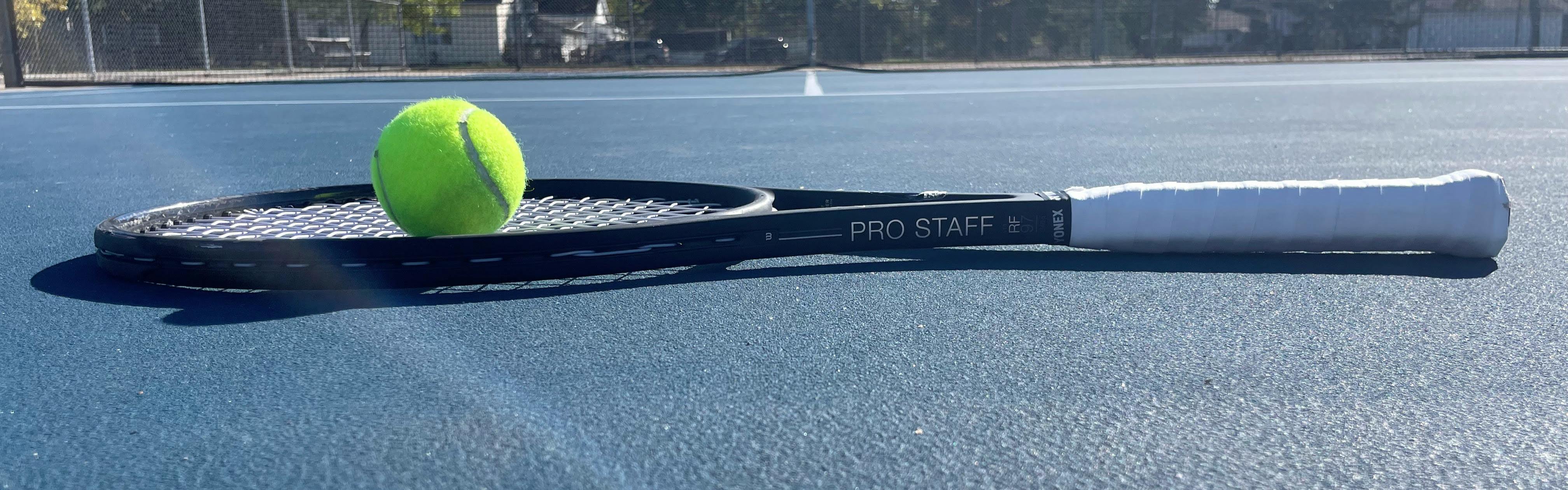 The Wilson Pro Staff RF 97 V13.0 Racquet on a tennis court. 