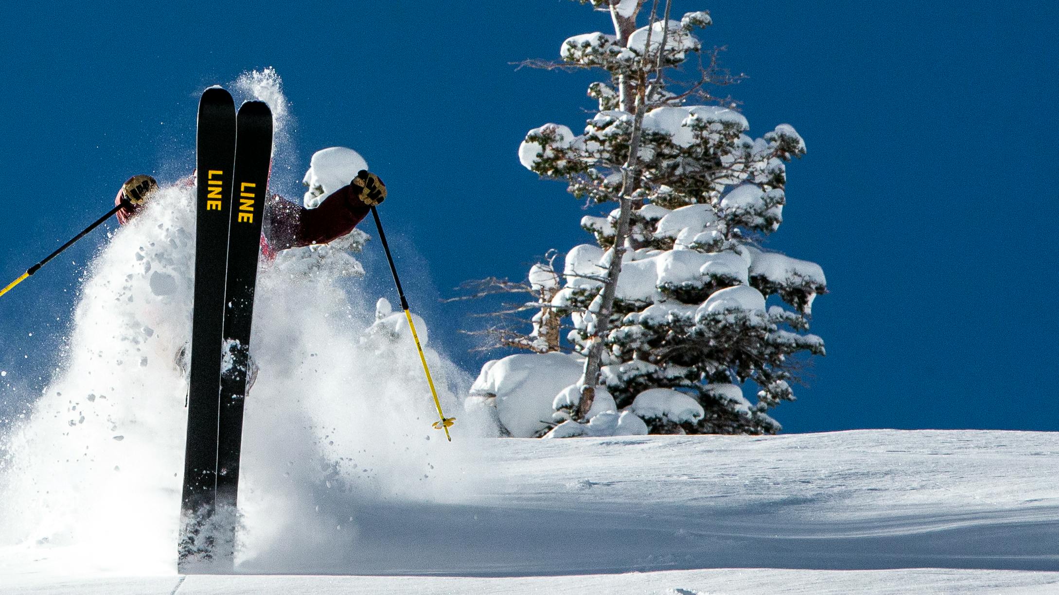 A skier doing a trick on Line skis. 