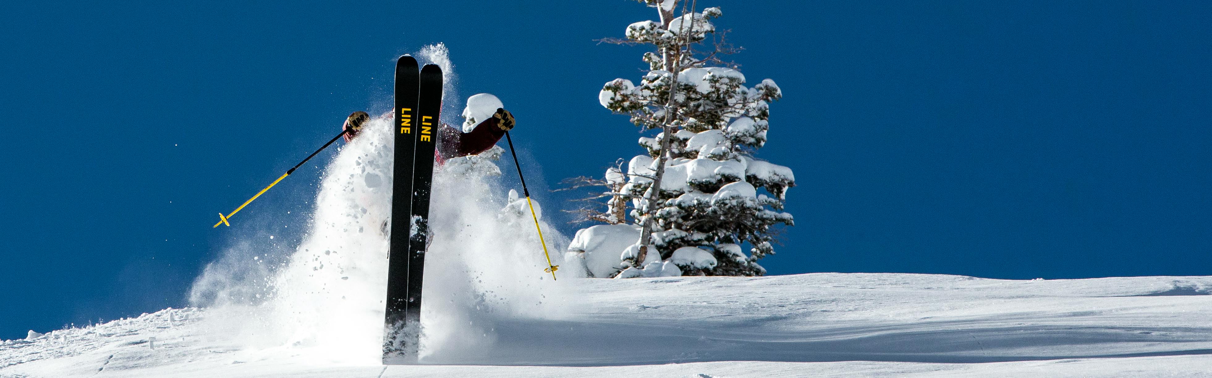 A skier doing a trick on Line skis. 