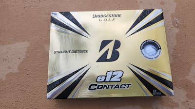 A box of the Bridgestone 2021 e12 Contact White Golf Balls.