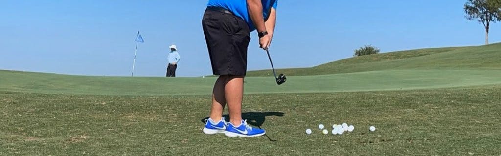 A man golfing with the Callaway Golf Jaws Raw Chrome Wedge.
