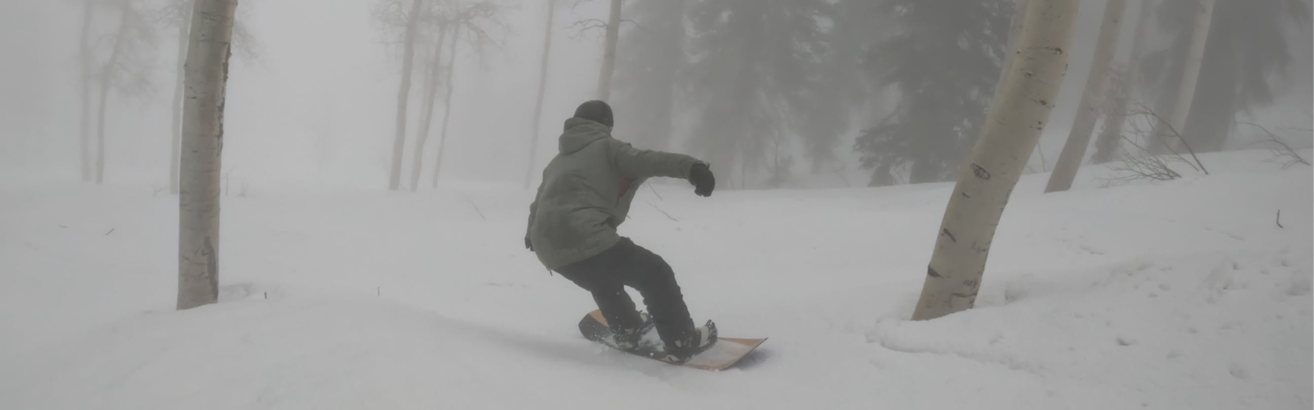 A snowboarder on the 2023 Salomon Assassin Snowboard.