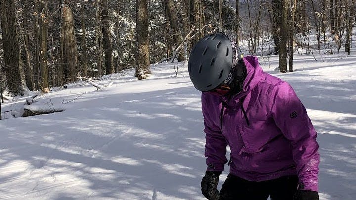 A snowboarder wearing the Smith Mission MIPS helmet. 