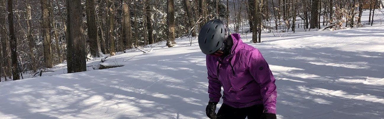 A snowboarder wearing the Smith Mission MIPS helmet. 
