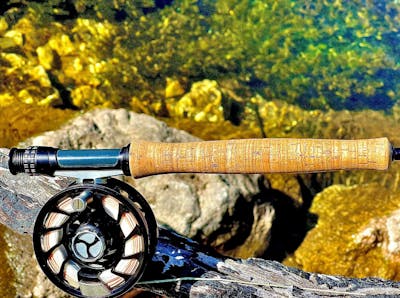 Handle of the Orvis Helio 3F Fly Rod with a reel attached.