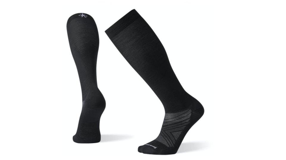 Two black lightweight - looking socks with some grey triangle design on the top of the foot. 