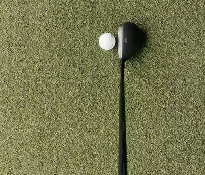 The Callaway Rogue ST Max OS Hybrid in front of a golf ball.