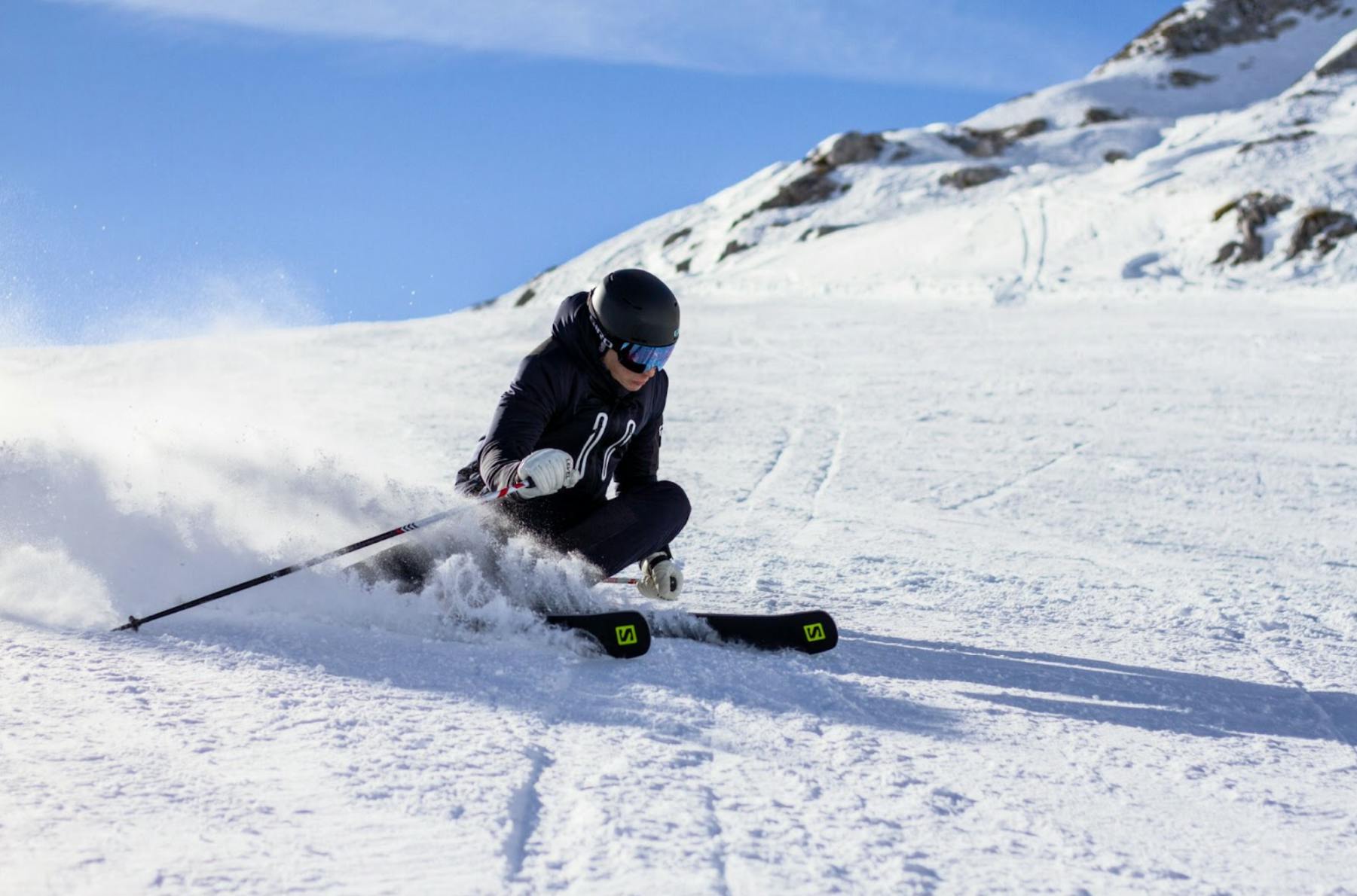 A skier carving down a ski run. 