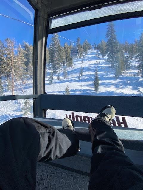 View of the DC Judge snowboard boots in a gondola at a ski area. 