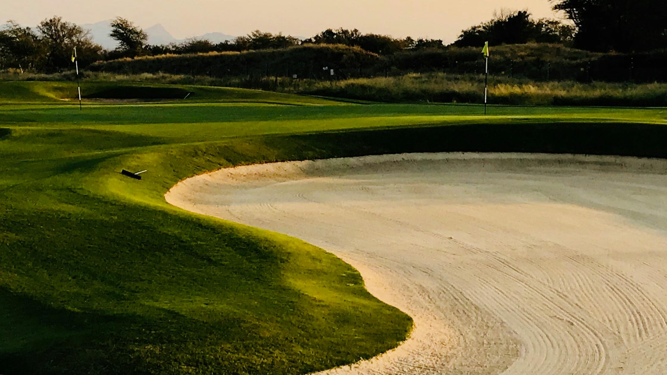 A close up of a sand pit on a golf hole.