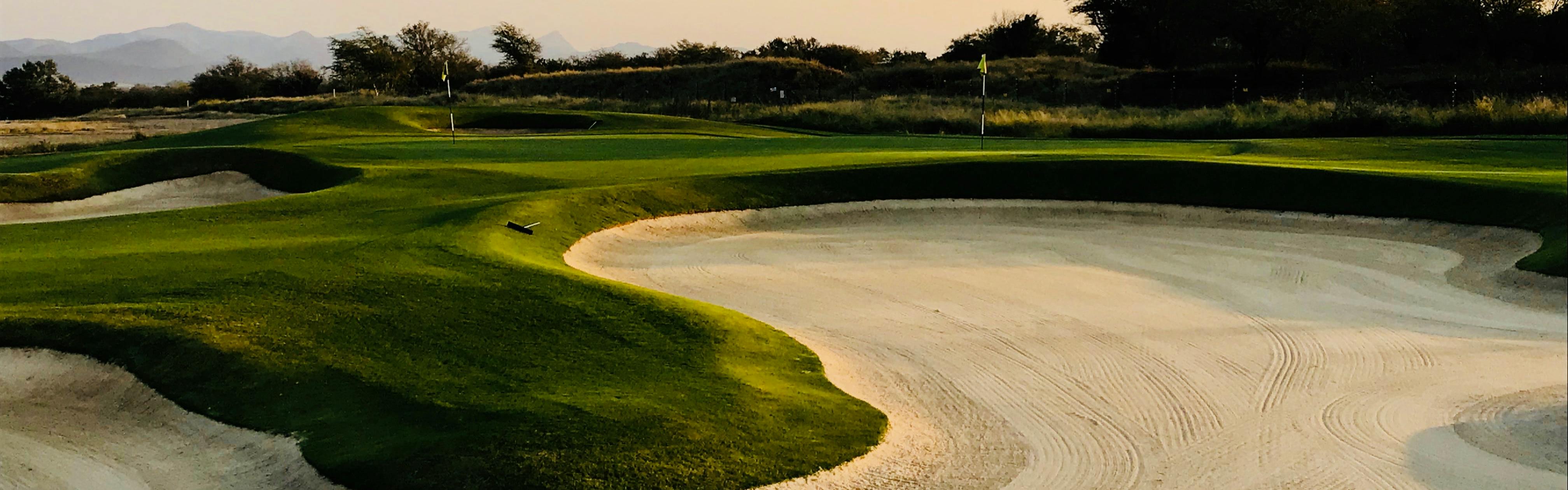 A close up of a sand pit on a golf hole.