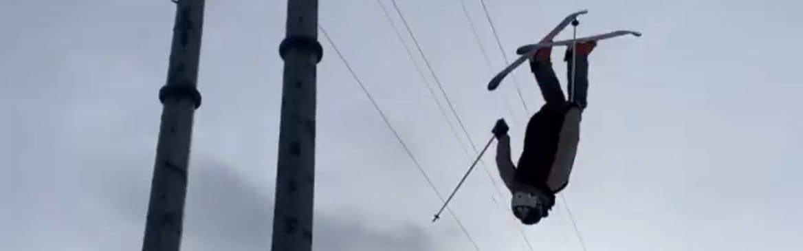 Skier flips upside down. 