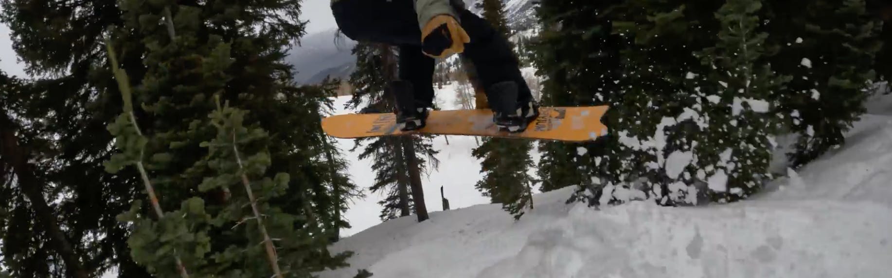 Snowboard Expert Spencer Storck jumping with the 2023 Nitro Dinghy snowboard