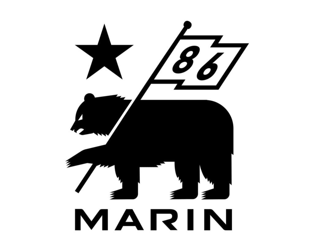 The Marin Bikes logos says "Marin" under the image of a bear holding a flag that says "86." A star sits above the bear's head. 