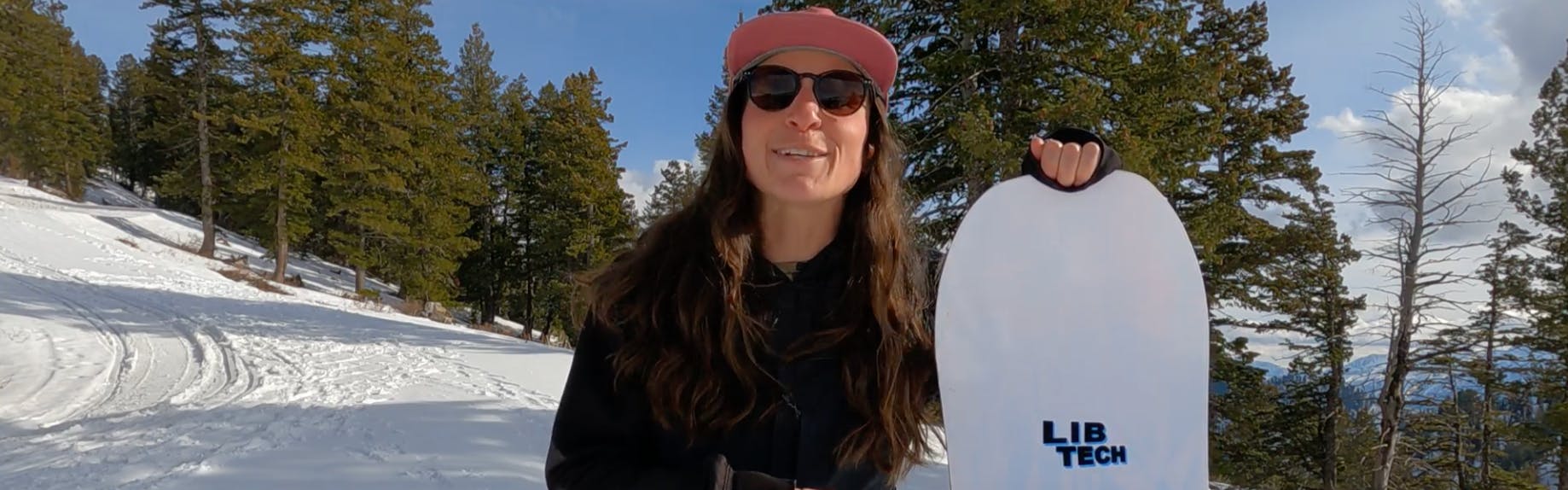 Snowboard Expert Arielle Busch standing with the 2023 Lib Tech Ryme snowboard