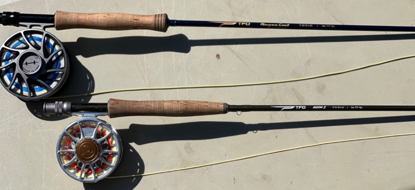 Two fly rods lie next to each other. 