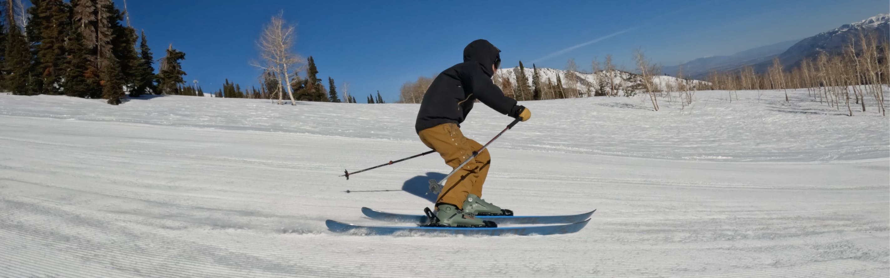 A skier turning on the 2023 Rossignol Blackops 98 Skis.