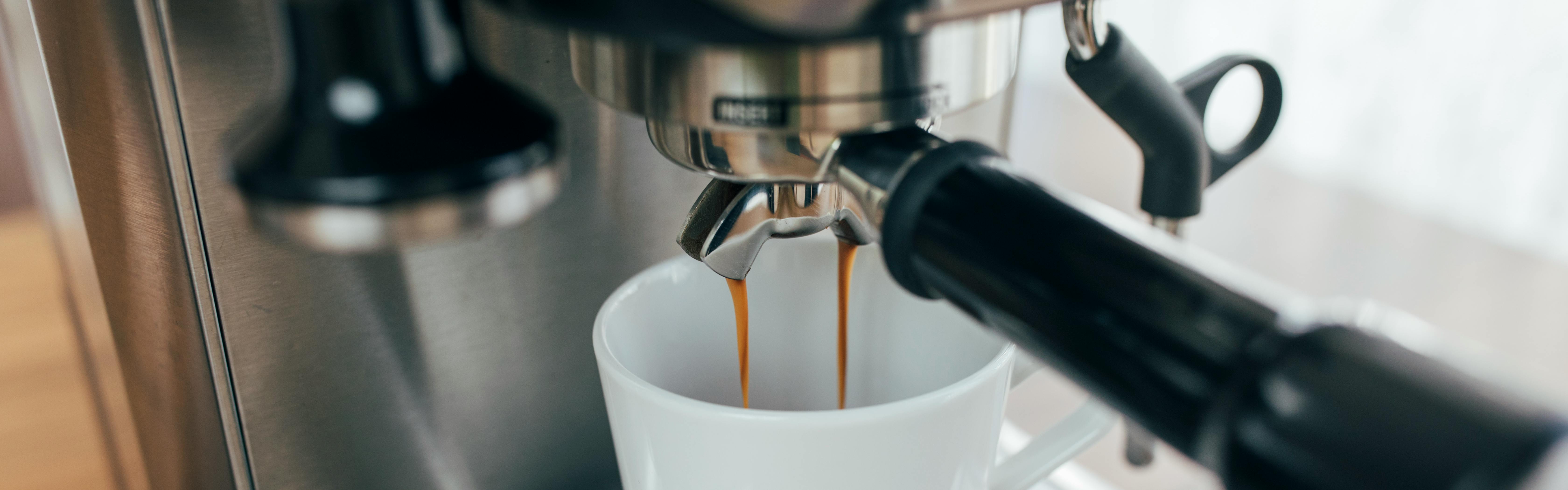 A cup of espresso being made with an espresso machine