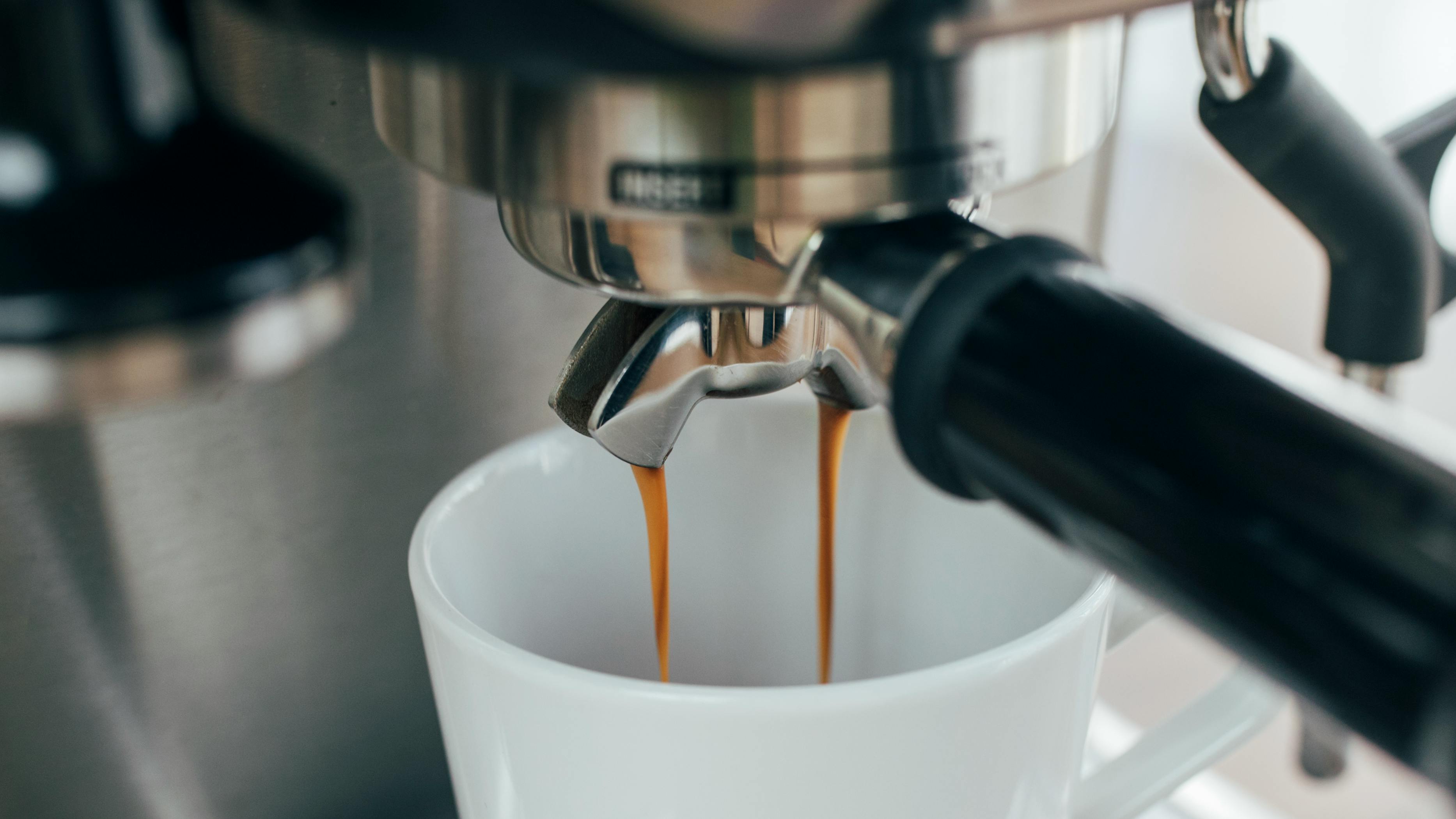 A cup of espresso being made with an espresso machine