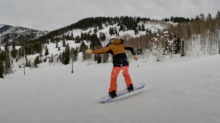 Snowboard Expert Sydney Johnson jumping with the Roxy XOXO Pro snowboard on a groomed run