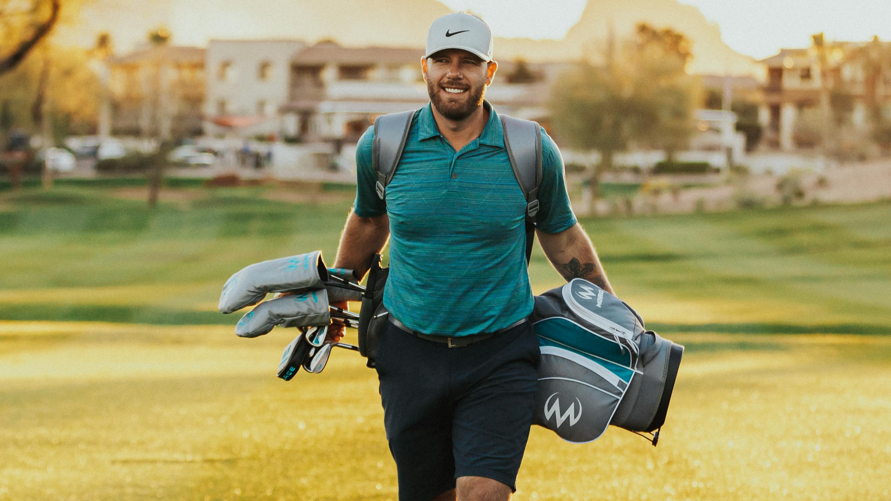 A man walking with a golf bag. 
