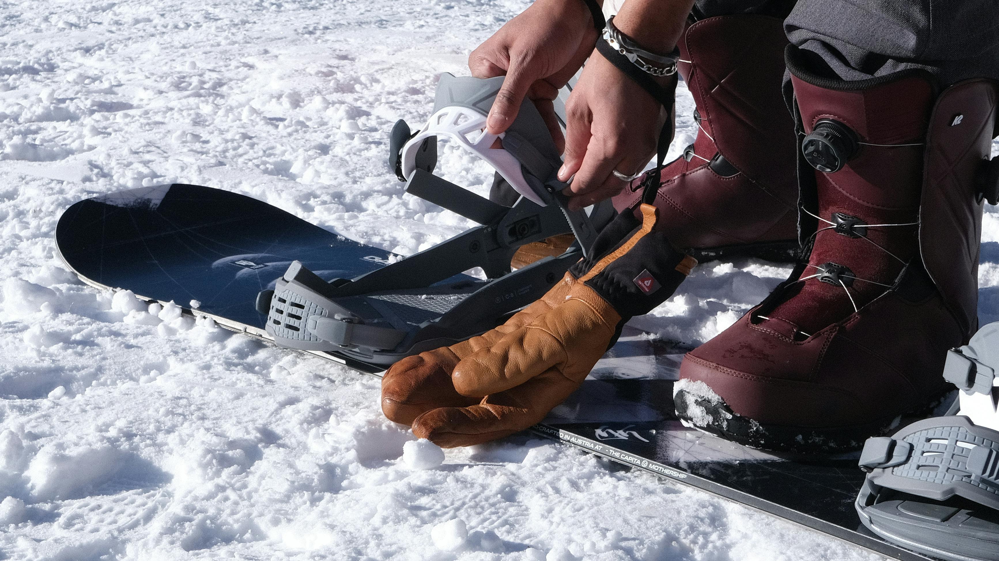 Strapping into a snowboard