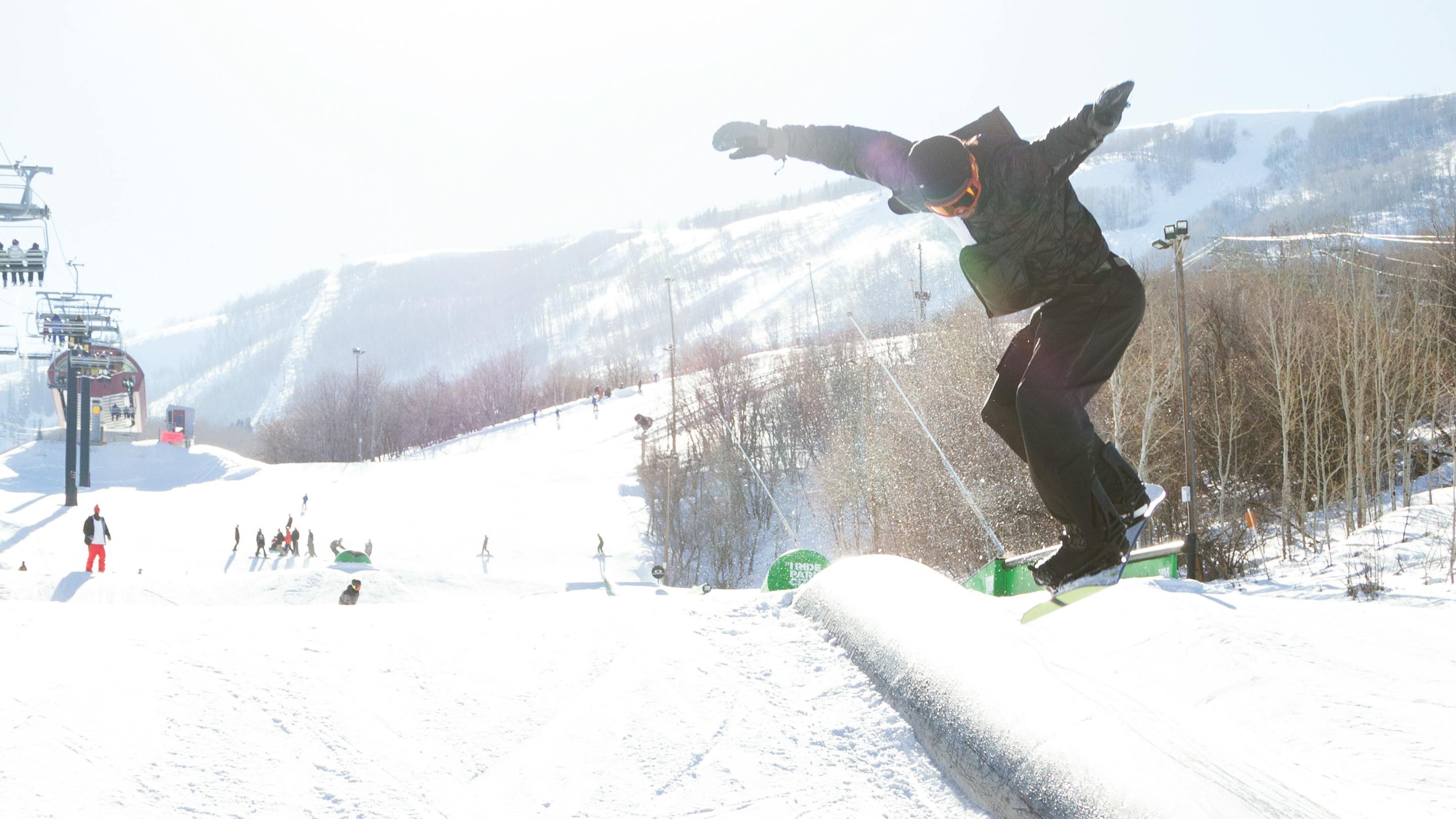 A snowboarder hitting a feature. 
