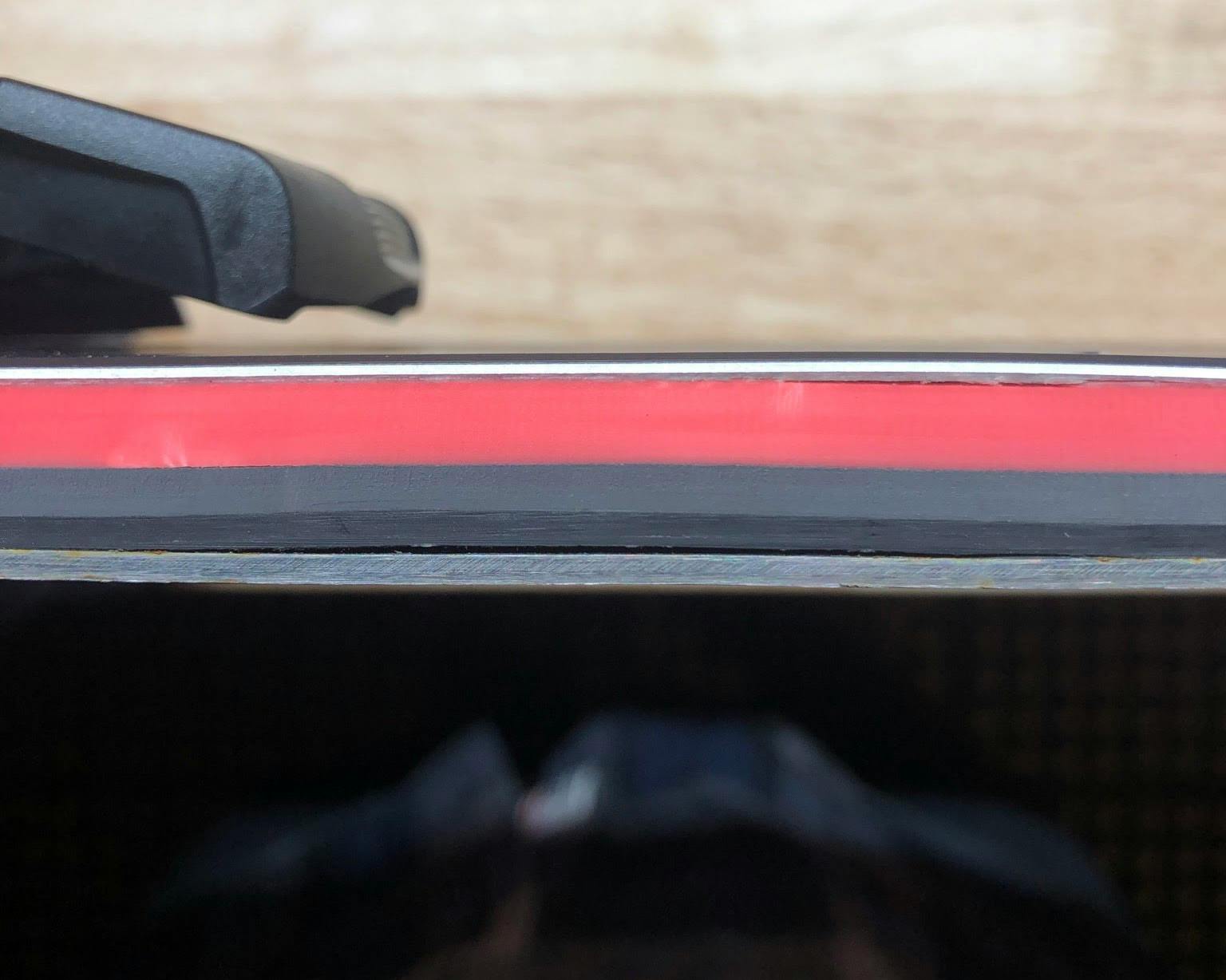 Close up photo of the edge of the skis, showing the delamination that has occured.