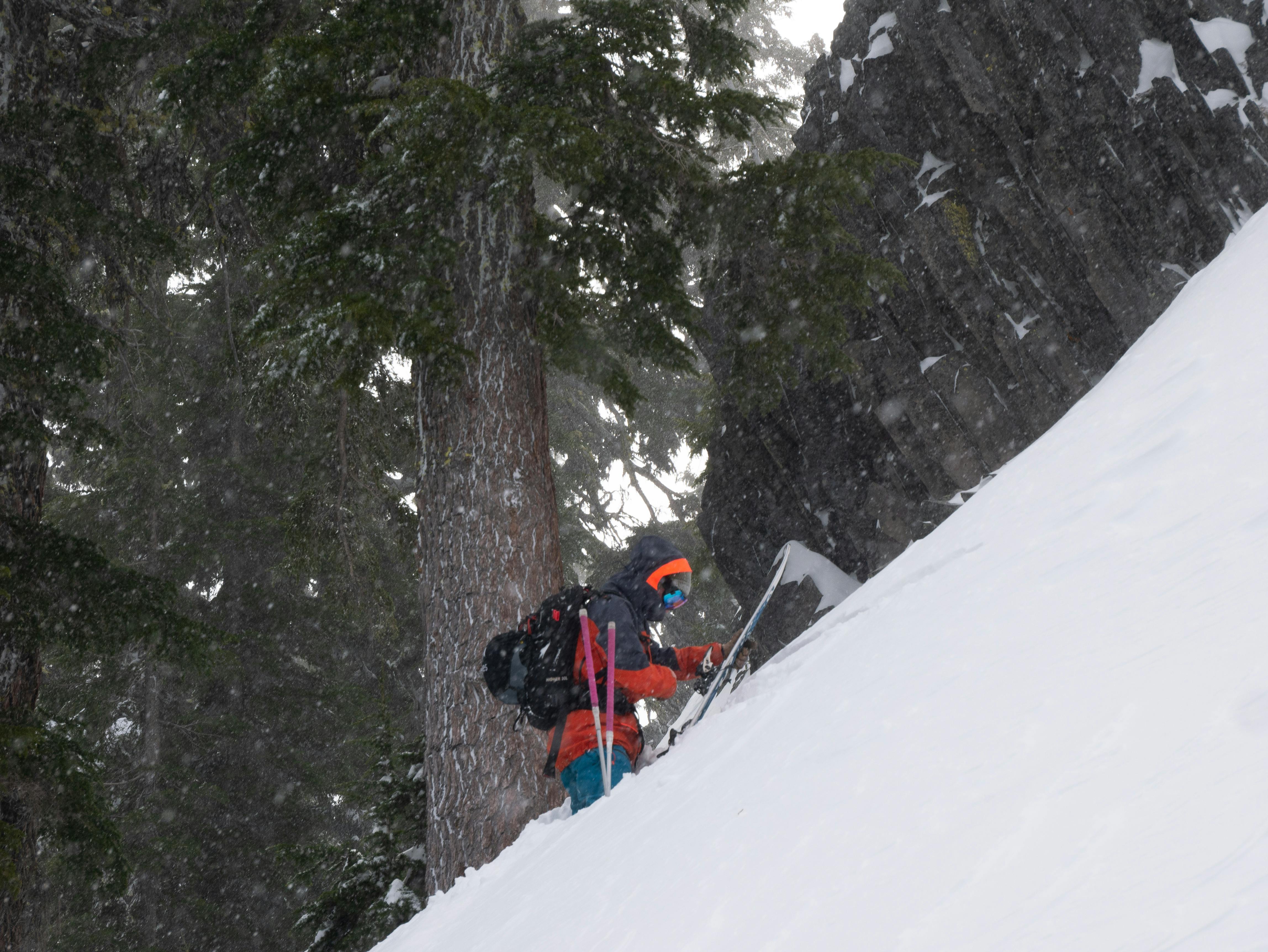 A backcountry skier digging a snow pit.