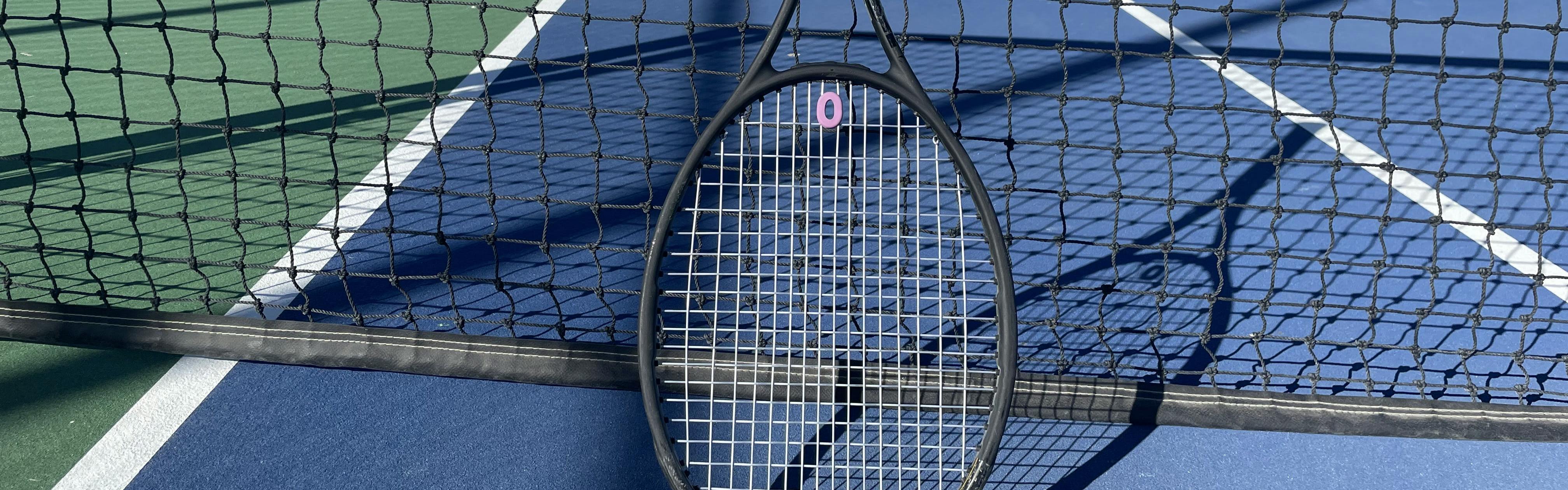 The Wilson Pro Staff 97 V13.0 Racquet · Unstrung laying on a tennis court. 
