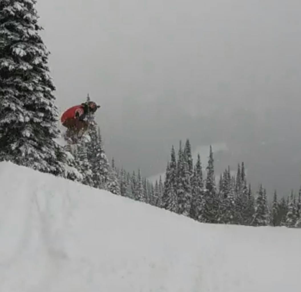 A snowboarder jumping off a jump. 