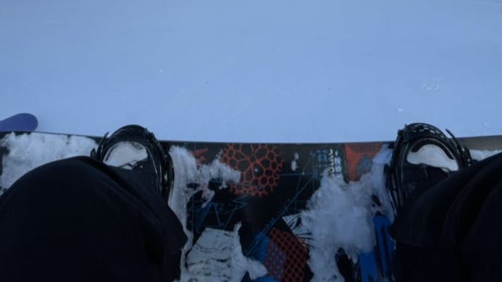 The Union Flite Pro Bindings attached to a snowboard on top of snow. 