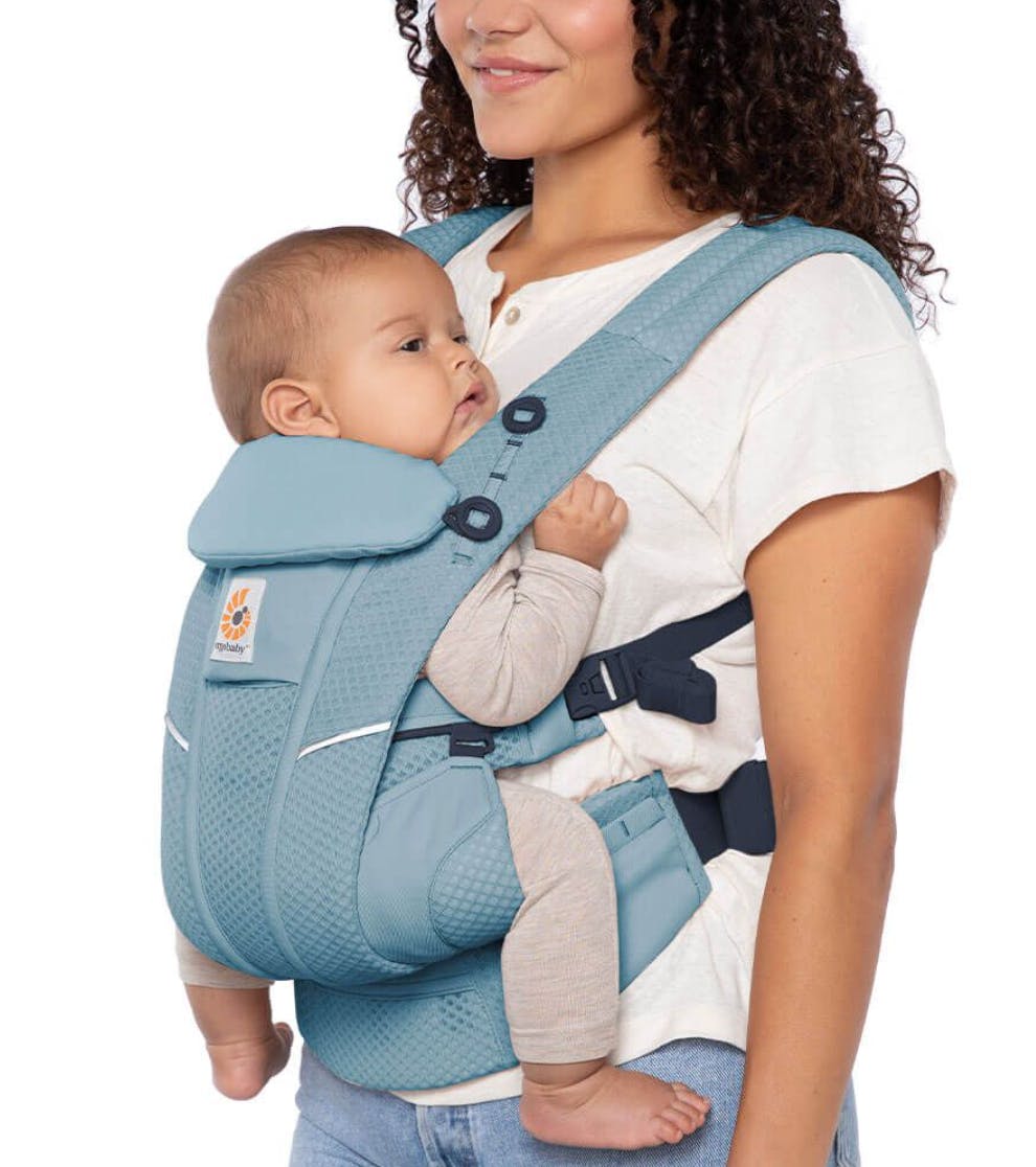 Woman uses the Ergobaby Omni Breeze Baby Carrier.