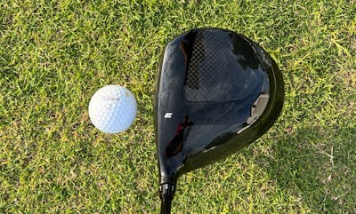 Top down view of the Tour Edge Exotics C721 Driver in front of a golf ball. 