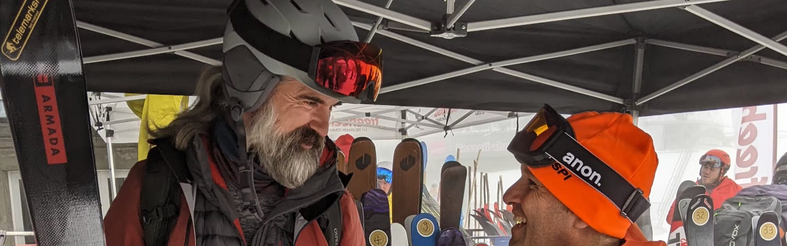 A man holding the Armada Declivity 88C skis in a tent. 