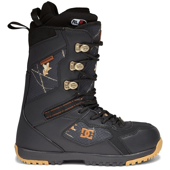 A black snowboard boot with brown on the soles.