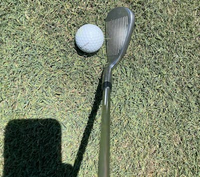 Top down view of the Callaway Rogue ST Max Iron in front of a golf ball. 