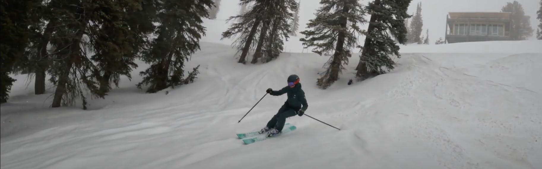Curated Ski Expert Sara Beeken skiing powder snow on the 2023 Black Crows Atris Birdie skis in foggy conditions