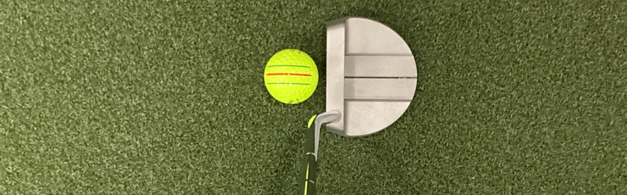 The Cleveland Huntington Beach SOFT #14 Single Bend Putter in front of a golf ball. 